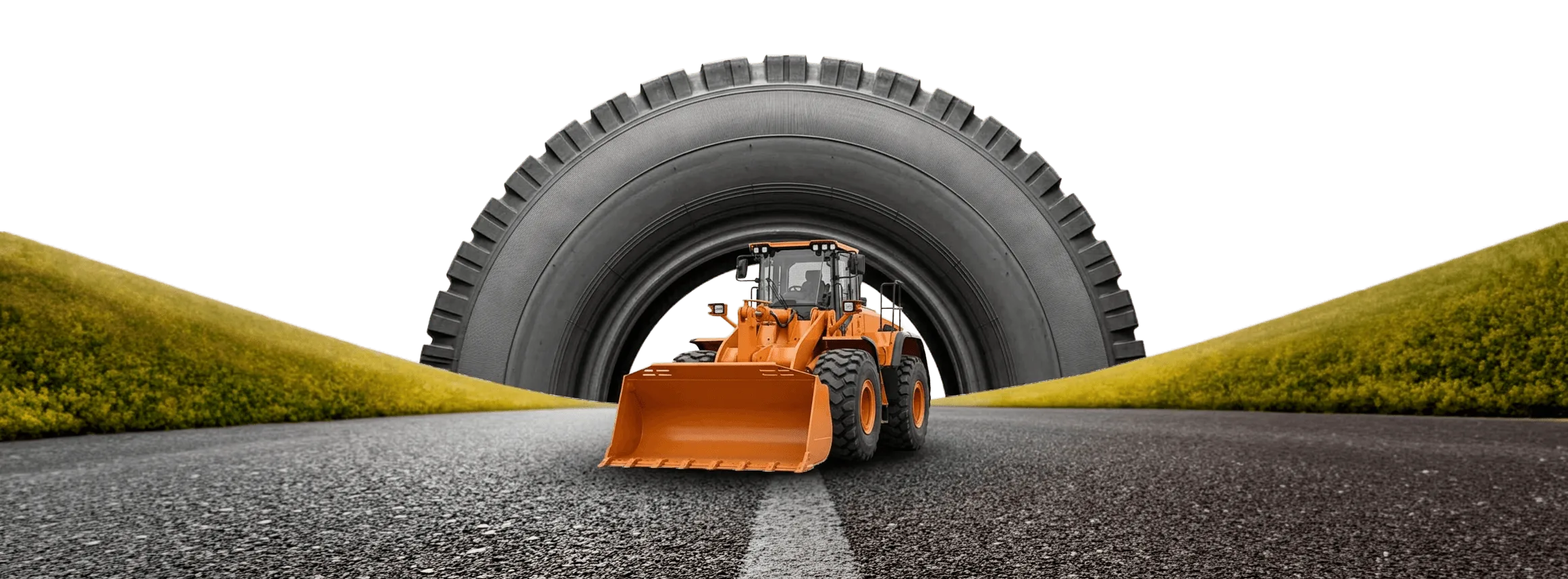 Orange wheel loader driving through a giant OTR tire on an open road
